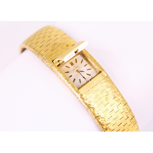 80 - A vintage ladies Omega 18ct yellow gold wristwatch, the rectangular dial with baton numerals and con... 