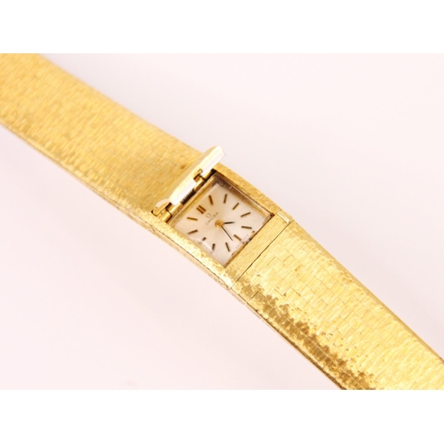 80 - A vintage ladies Omega 18ct yellow gold wristwatch, the rectangular dial with baton numerals and con... 