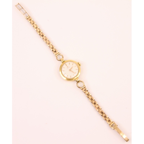 83 - A yellow metal ladies Omega wrist watch, the circular white dial with baton markers, 22mm wide inclu... 