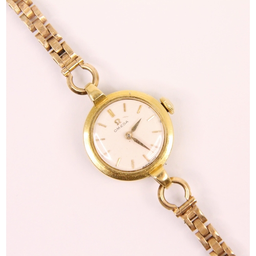 83 - A yellow metal ladies Omega wrist watch, the circular white dial with baton markers, 22mm wide inclu... 