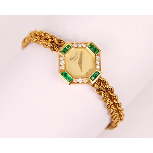 84 - A ladies Chopard emerald and diamond yellow metal wristwatch, the circular champagne coloured dial s... 