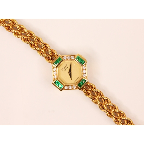 84 - A ladies Chopard emerald and diamond yellow metal wristwatch, the circular champagne coloured dial s... 