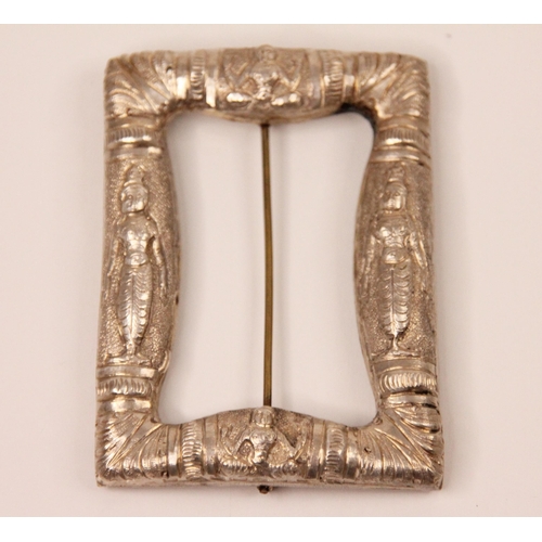 119 - An Eastern white metal buckle, the rectangular buckle with cast figural decoration, 6.5cm long, with... 