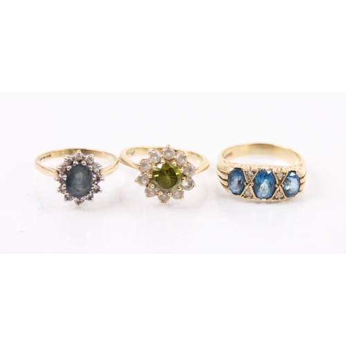 141 - A selection of diamond and paste rings, including a graduated blue stone ring within a carved yellow... 