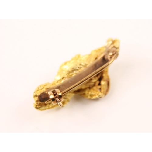 170 - A yellow metal 'nugget' brooch, the free form brooch with all over textured detail, with hinge pin a... 