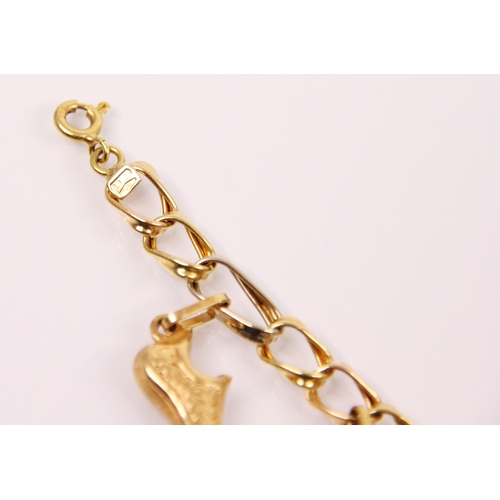 181 - A two tone yellow and white metal charm bracelet, the fancy curb link bracelet suspending ten charms... 