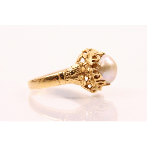 183 - A cultured pearl and yellow metal ring, the central baroque shaped untested pearl set within an open... 