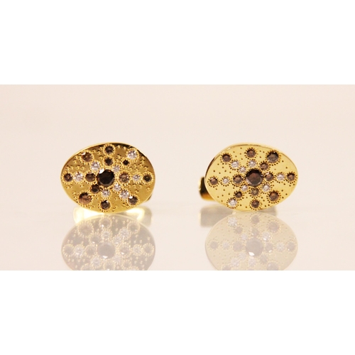 191 - A pair of De Beers 'Talisman' diamond cufflinks, the oval shaped yellow metal cufflinks with central... 