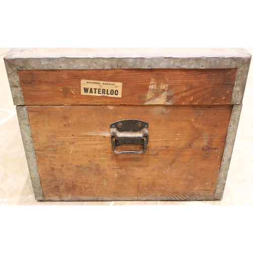 559 - A metal bound pine storage/travel trunk, early 20th century, applied with iron side swing handles an... 