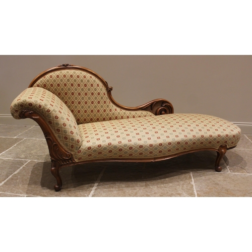 777 - A Victorian carved walnut framed chaise longue, later re-upholstered in lattice floral fabric, the d... 