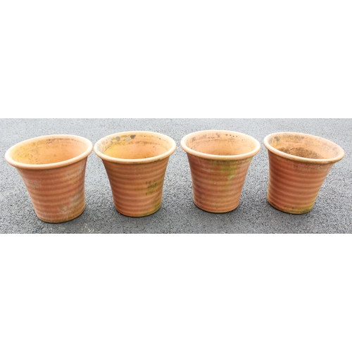 813 - A set of four terracotta planters, of inverted ribbed bell form, 37cm H x 42cm D (4)