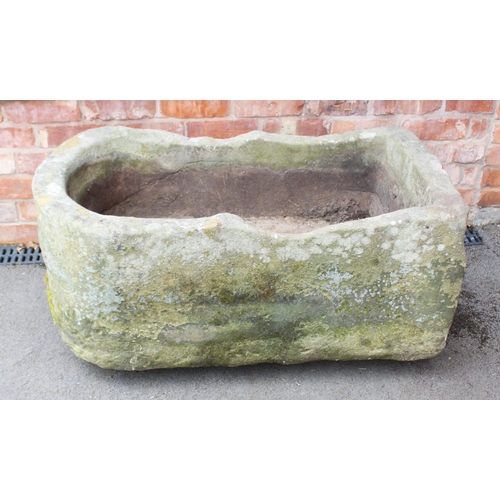 818 - A 19th century bow fronted sandstone pump trough, with drain hole to one side, 40cm H x 109cm W x 60... 