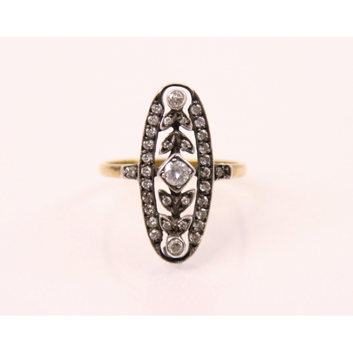 94 - An Edwardian style diamond ring, the central round cut diamond with diamond set leaf and white metal... 