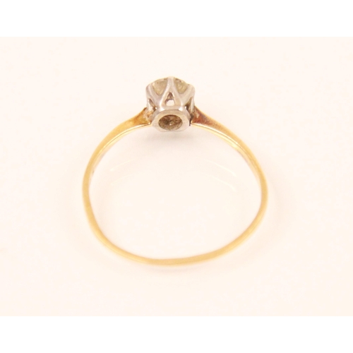 95 - An Edwardian diamond solitaire ring, the old cut diamond in white metal six claw setting, leading to... 