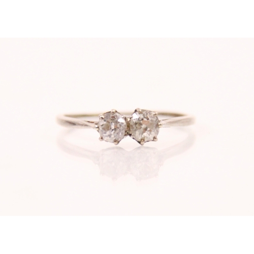 96 - An early 20th century diamond two stone ring, the old cut diamond with a smaller old cut diamond alo... 