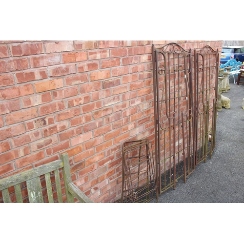 819 - A pair of wrought iron folding garden arbours, with open scroll work side panels, each measures 185c... 