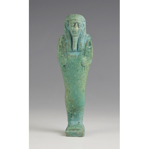 203 - An Egyptian blue glazed Shabti figure, in the style of 21st Dynasty examples (circa 1070-945 B.C), b... 