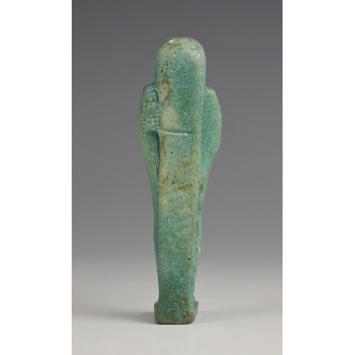 203 - An Egyptian blue glazed Shabti figure, in the style of 21st Dynasty examples (circa 1070-945 B.C), b... 