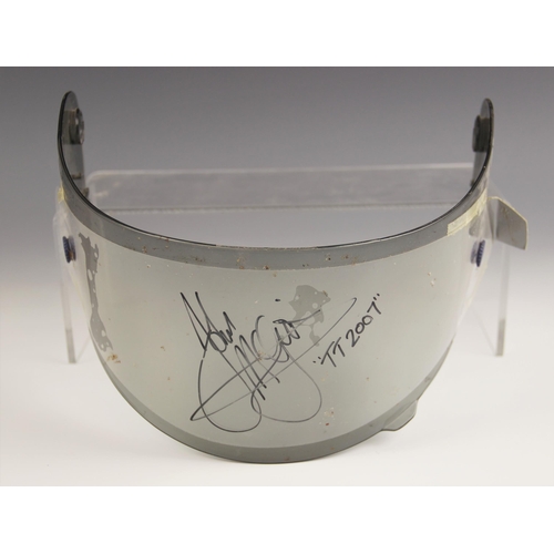 224 - ISLE OF MAN TT/MOTORCYCLE GRAND PRIX INTEREST: A Shoei motorcycle helmet visor signed by John McGuin... 