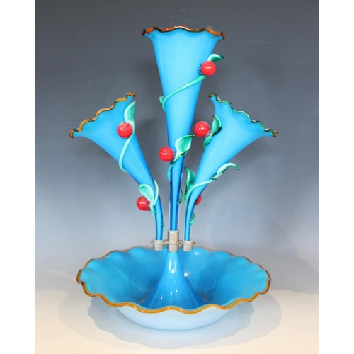 487 - A vibrant blue opaque glass epergne, with a central trumpet over two smaller trumpets, each with fla... 