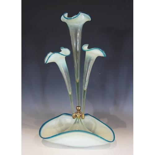 490 - A milk glass epergne, with a central trumpet over three smaller trumpets, all with crimped clear gla... 