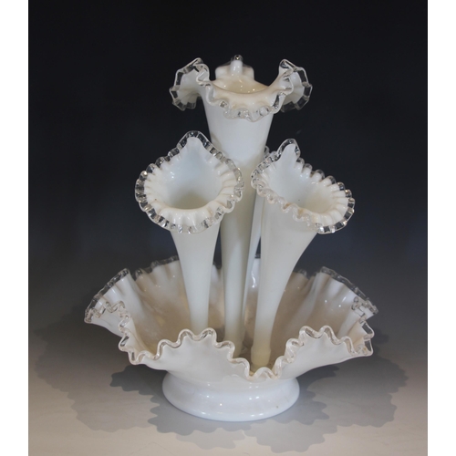 490 - A milk glass epergne, with a central trumpet over three smaller trumpets, all with crimped clear gla... 