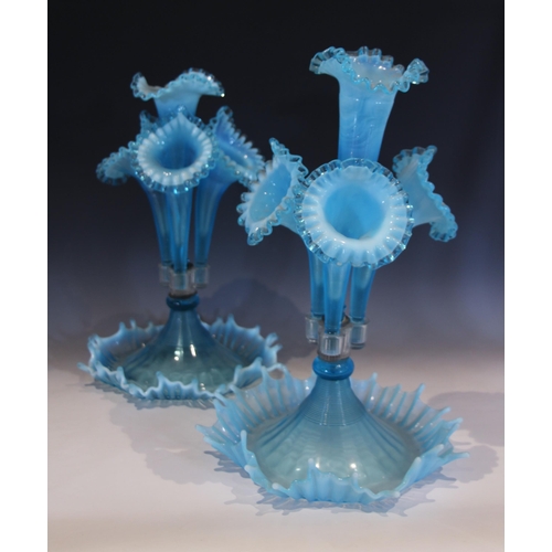 491 - Two pale blue vaseline glass epergnes, each with a central trumpet over three smaller trumpets, each... 