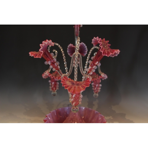 499 - A cranberry glass epergne of typical form, with central trumpet over three lower trumpets, and three... 