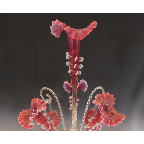 499 - A cranberry glass epergne of typical form, with central trumpet over three lower trumpets, and three... 