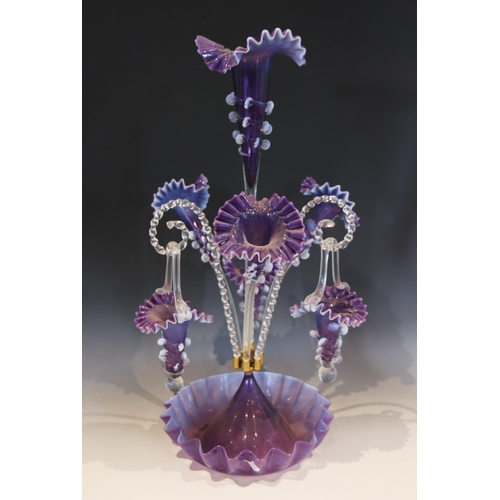 500 - An amethyst glass epergne of typical form, with central trumpet over three lower trumpets, and three... 