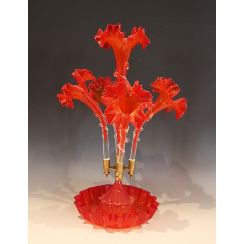 502 - An amber glass epergne of typical form, with central trumpet over four lower trumpets, all with crim... 