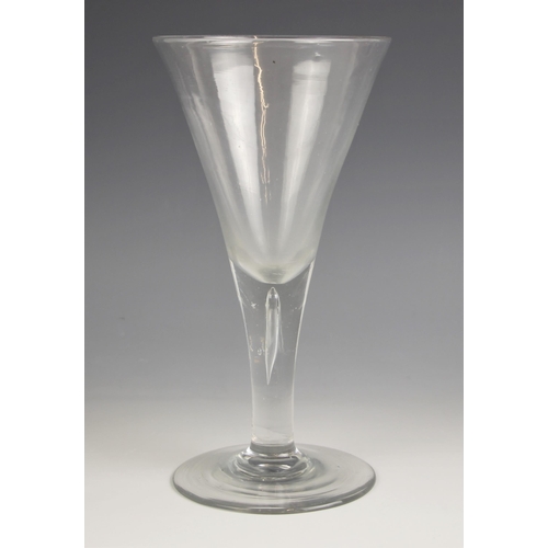 514 - A wine glass of large proportions, of conical form, the tapering teardrop stem on low domed foot, pa... 