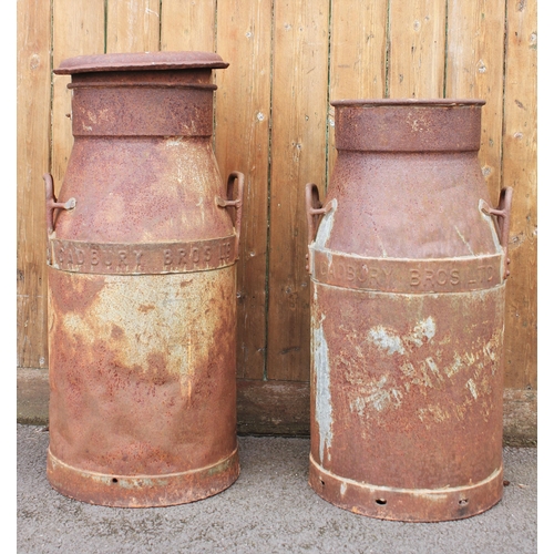 540 - A pair of vintage milk churns, both cast in relief 'Cadbury Bros Ltd', one with lid, 69cm and 75cm h... 