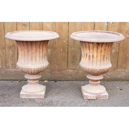 619 - A pair of Victorian cast iron garden campana urns, of typical fluted form, 48cm H x 42cm D