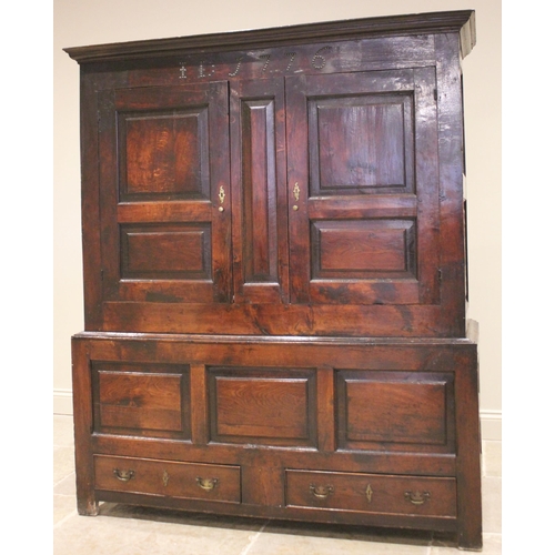 712 - A late 18th century oak jointed livery cupboard, probably Welsh, the moulded cornice above a frieze ... 