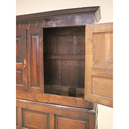 712 - A late 18th century oak jointed livery cupboard, probably Welsh, the moulded cornice above a frieze ... 