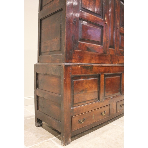 712 - A late 18th century oak jointed livery cupboard, probably Welsh, the moulded cornice above a frieze ... 