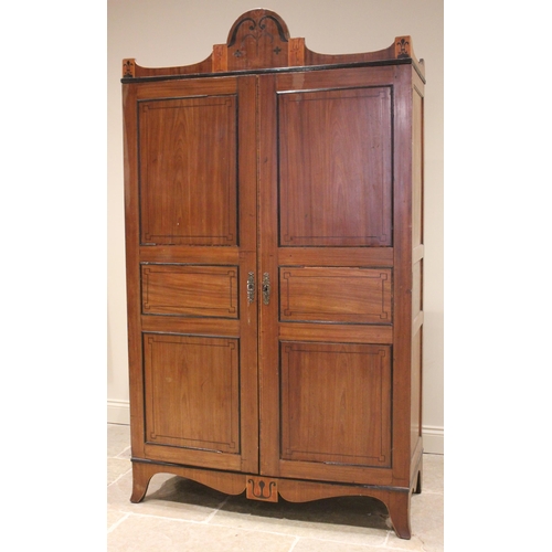 730 - A late George III mahogany wardrobe, possibly Channel Islands, the arched cornice inlaid with stylis... 