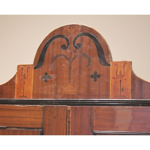 730 - A late George III mahogany wardrobe, possibly Channel Islands, the arched cornice inlaid with stylis... 