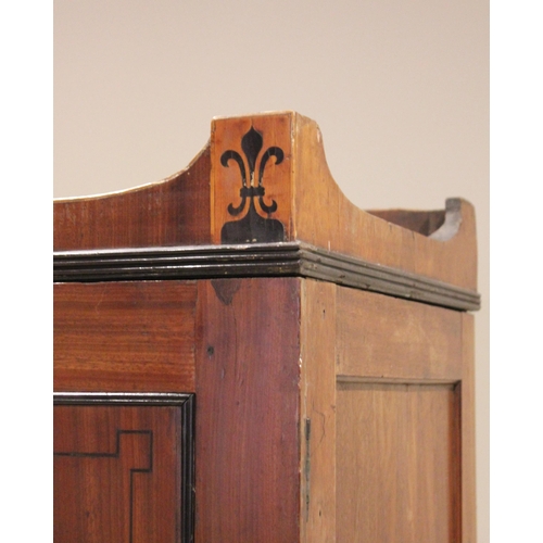 730 - A late George III mahogany wardrobe, possibly Channel Islands, the arched cornice inlaid with stylis... 