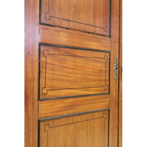 730 - A late George III mahogany wardrobe, possibly Channel Islands, the arched cornice inlaid with stylis... 