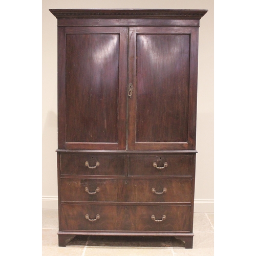 762 - A 19th century mahogany linen press, the moulded cornice over a pair of panelled doors opening to a ... 