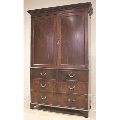 762 - A 19th century mahogany linen press, the moulded cornice over a pair of panelled doors opening to a ... 