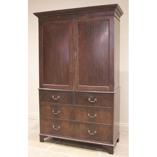 762 - A 19th century mahogany linen press, the moulded cornice over a pair of panelled doors opening to a ... 