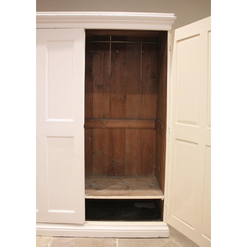 763 - A Victorian country house painted pitch pine hall/storage cupboard, the moulded cornice above a pair... 