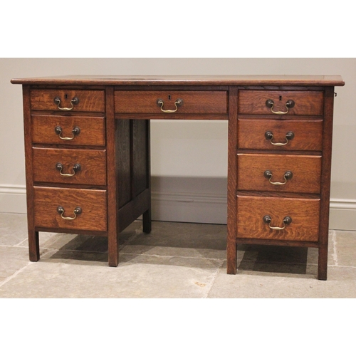 786 - An early 20th century oak kneehole desk, the rectangular top with replaced inset skiver, over a cent... 