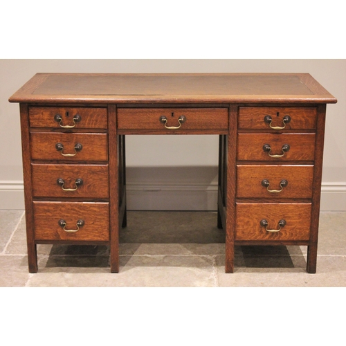 786 - An early 20th century oak kneehole desk, the rectangular top with replaced inset skiver, over a cent... 