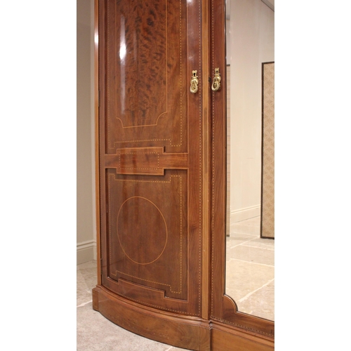 791 - An Edwardian mahogany inlaid triple wardrobe, by Warings, of inverted breakfront form, the central m... 