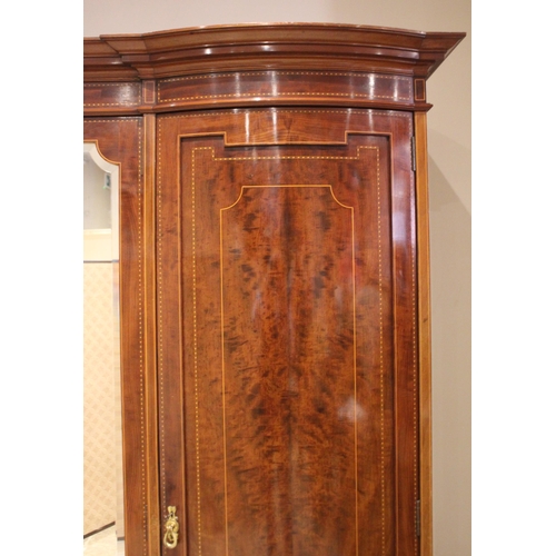 791 - An Edwardian mahogany inlaid triple wardrobe, by Warings, of inverted breakfront form, the central m... 