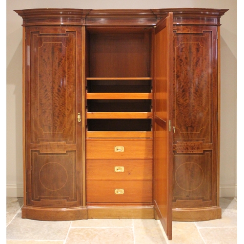 791 - An Edwardian mahogany inlaid triple wardrobe, by Warings, of inverted breakfront form, the central m... 